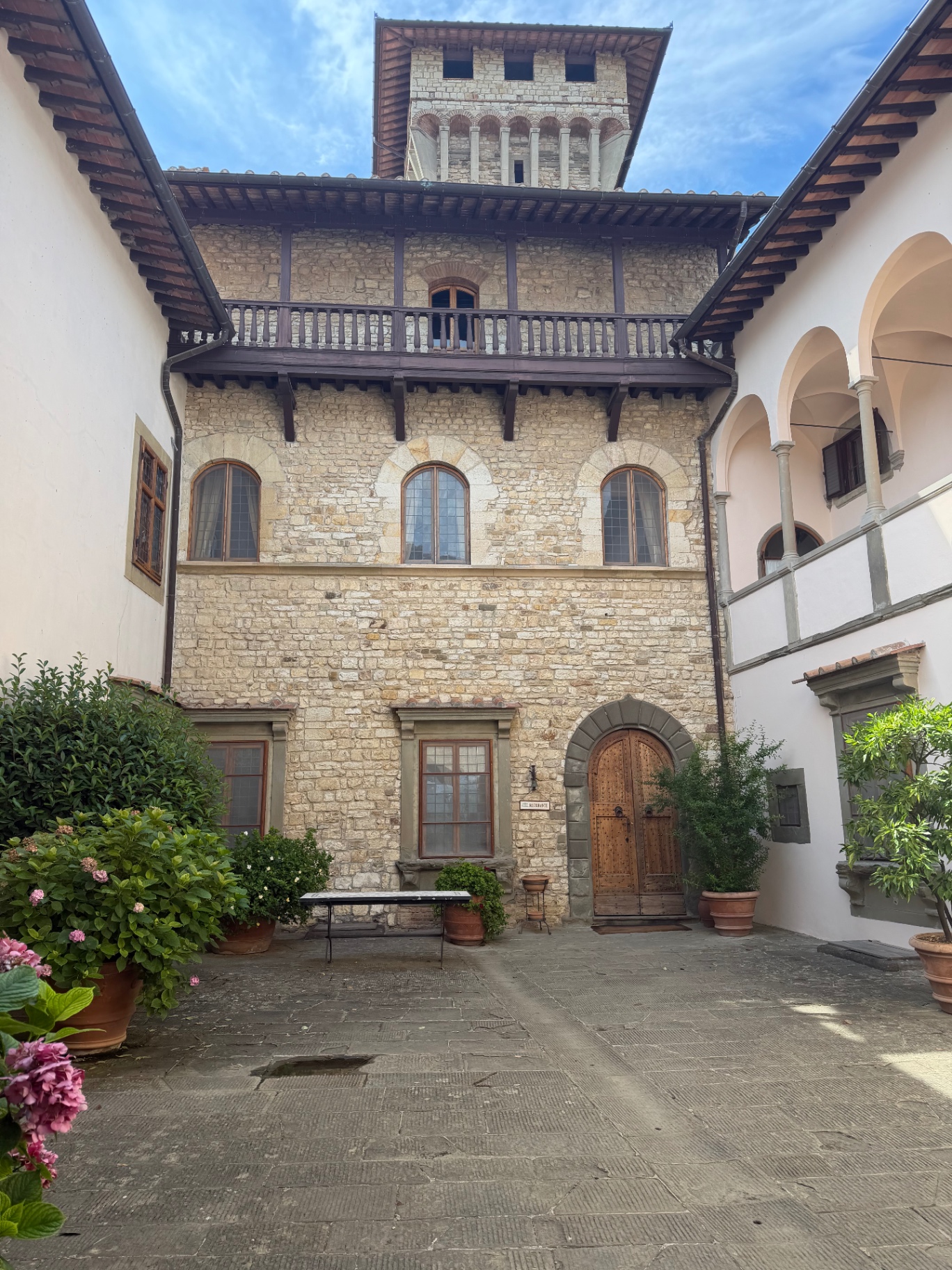 Historic stone courtyard and tower at Castello Vicchiomaggio in Chianti, Tuscany